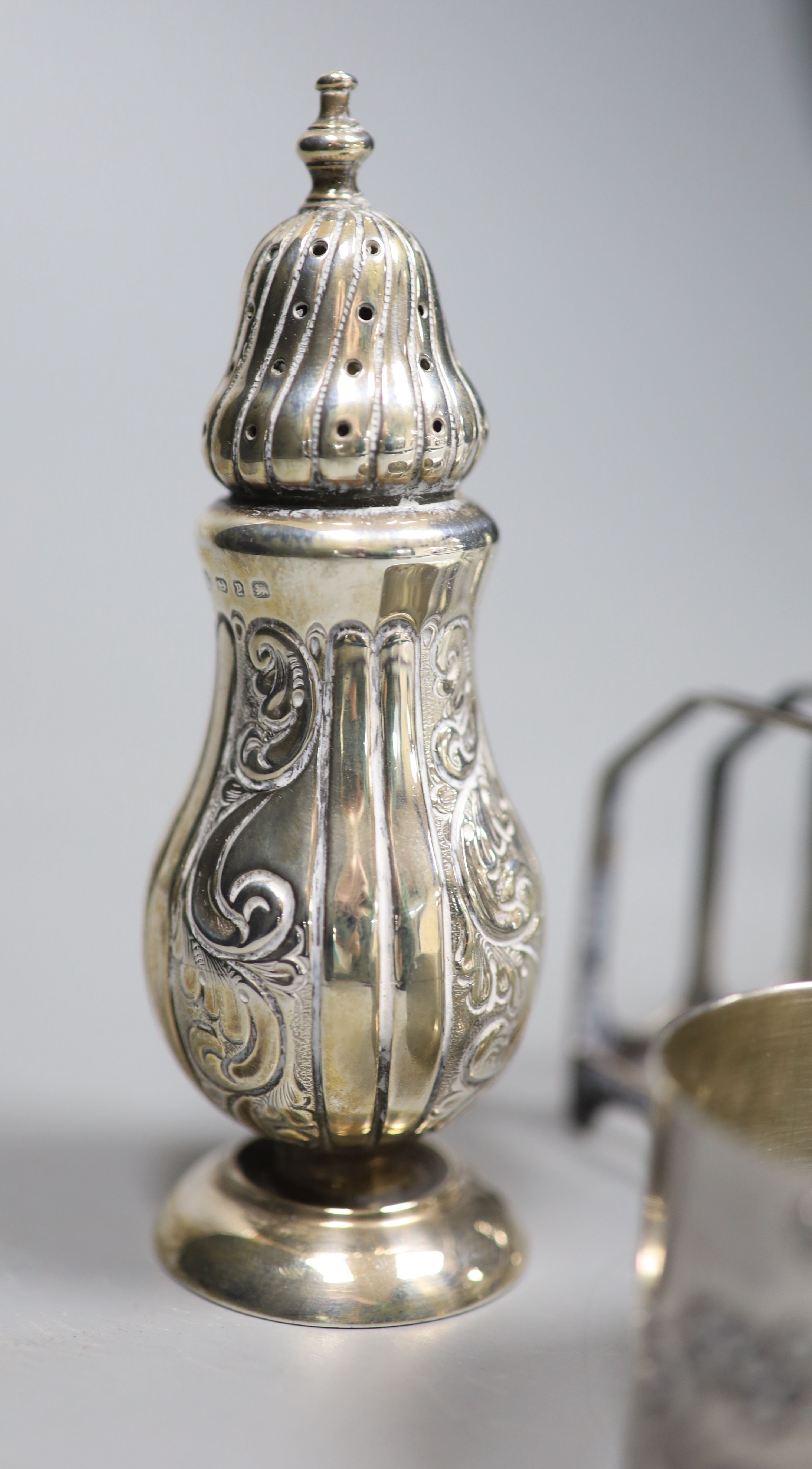 A pair of late Victorian silver pepperettes, Birmingham, 1898, 11.9cm(a.f.) & other items.